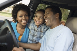  boy and parents in car