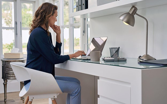 Woman working on Greenhouse Gas Emissions per Laptop